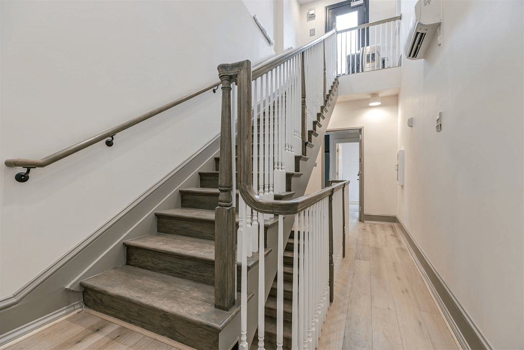 a staircase in a home with wood floors and white walls